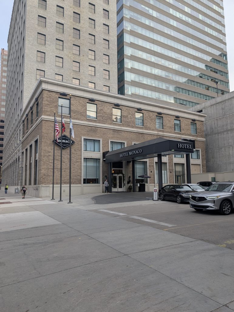 The Kimpton Hotel Monaco, Salt Lake City, 15 W 200 S, Salt Lake City, UT 84101. The photo is taken after turning into the hotel parking lot coming east on 200 S.